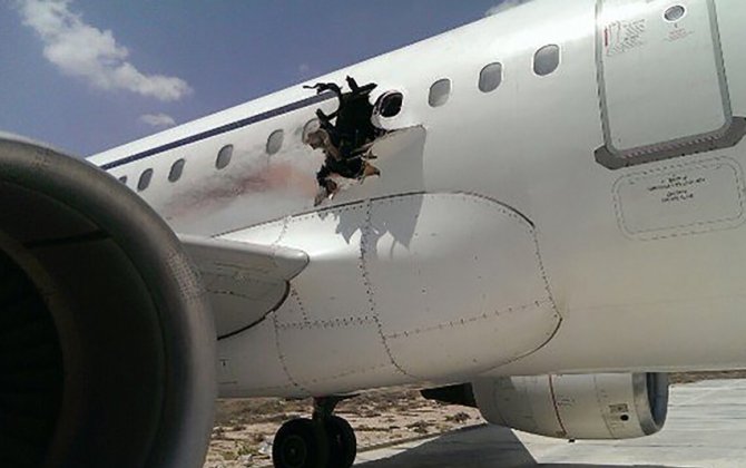 Plane makes emergency landing after explosion tears gaping hole in its side